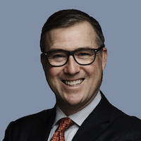 Headshot of attorney Chris Colvin with grayish blue background.