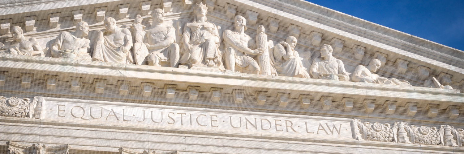 Pediment of a white marble courtouse engraved with the words "Equal Justice Under Law"