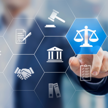 Commercial & Financial — Litigation & Regulatory Practices A photograph with a blurred image of a person pressing their finger on an icon showing scales of justice.