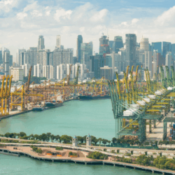 Cross-Border Litigation & Coordination A photograph of shipping port with cargo tankers, with a city skyline in the background.